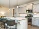 This is a kitchen with granite countertops, stainless steel appliances and stylish pendant lighting at 1941 Bright Kannon Way, Wendell, NC 27591