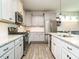 Open kitchen with stainless appliances, granite counters, and grey and white cabinets at 1941 Bright Kannon Way, Wendell, NC 27591