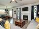 Open concept living room with a fireplace, sliding doors to backyard, and ample natural light at 1941 Bright Kannon Way, Wendell, NC 27591