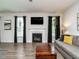 Spacious living room with a fireplace, large windows, and modern decor at 1941 Bright Kannon Way, Wendell, NC 27591