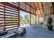 A covered patio area with comfortable seating overlooking the pool area and well-manicured landscaping at 1941 Bright Kannon Way, Wendell, NC 27591