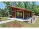 An open-air pavilion with wooden beams, picnic tables, and surrounding trees at 1941 Bright Kannon Way, Wendell, NC 27591