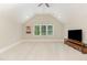 Bonus room includes a ceiling fan, vaulted ceilings, and a TV with built-in storage at 2016 Falls Forest Dr, Raleigh, NC 27615