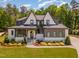 Beautiful two-story home featuring a landscaped yard, gray trim, and a striking front entrance with a glass door at 2016 Falls Forest Dr, Raleigh, NC 27615