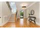 Staircase and entry hall showcasing wood floors, modern lighting, and stylish decor at 2016 Falls Forest Dr, Raleigh, NC 27615