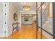 Bright foyer with wood floors, decorative light fixture, and views into the living room and staircase at 2016 Falls Forest Dr, Raleigh, NC 27615