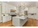 Elegant kitchen with a large island, marble countertops, stainless steel appliances, and ample storage at 2016 Falls Forest Dr, Raleigh, NC 27615