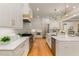 Spacious kitchen features an island, stainless steel appliances, and ample storage in white cabinets at 2016 Falls Forest Dr, Raleigh, NC 27615