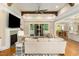 Comfortable living room with beamed ceiling, fireplace, hardwood floors, and backyard views at 2016 Falls Forest Dr, Raleigh, NC 27615