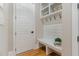 Bright mudroom with a built-in bench, cubbies, hooks, and an exterior door at 2016 Falls Forest Dr, Raleigh, NC 27615