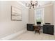 Neutral office with dark built-in cabinets, granite countertops, and a decorative light fixture at 2016 Falls Forest Dr, Raleigh, NC 27615