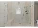Bright bathroom with a glass shower with shower head and seat at 2016 Falls Forest Dr, Raleigh, NC 27615