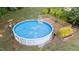 Aerial view of an above-ground pool with a wooden deck in a landscaped backyard at 205 Smiths Creek Dr, Clayton, NC 27520