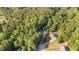 Aerial view showcasing homes with swimming pools amidst a lush, green landscape at 205 Smiths Creek Dr, Clayton, NC 27520