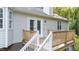 Charming back deck with wood railing and stairs leading to the backyard at 205 Smiths Creek Dr, Clayton, NC 27520