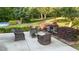 Outdoor patio area with wicker chairs, a table, and a charming fireplace at 205 Smiths Creek Dr, Clayton, NC 27520