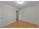 This bedroom features light-colored walls and wood-look laminate flooring at 205 Smiths Creek Dr, Clayton, NC 27520