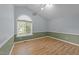 This bedroom features vaulted ceiling, wood flooring, and two-tone paint at 205 Smiths Creek Dr, Clayton, NC 27520