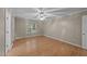 This bedroom features a ceiling fan, wood flooring, and a window at 205 Smiths Creek Dr, Clayton, NC 27520