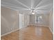 This bedroom features a ceiling fan, wood flooring, and two entry doors at 205 Smiths Creek Dr, Clayton, NC 27520
