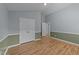 This bedroom features wood-look flooring, two-tone paint, and a double closet at 205 Smiths Creek Dr, Clayton, NC 27520