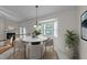 Bright dining area with chandelier and bay window, showcasing a cozy space for meals at 205 Smiths Creek Dr, Clayton, NC 27520