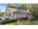 Charming home exterior with a spacious backyard, wooden deck, and mature trees at 205 Smiths Creek Dr, Clayton, NC 27520
