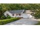 Home featuring a 2-car garage, manicured lawn, and charming front porch at 205 Smiths Creek Dr, Clayton, NC 27520