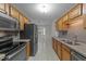 Well-equipped kitchen featuring stainless steel appliances and ample wooden cabinetry at 205 Smiths Creek Dr, Clayton, NC 27520