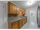 Functional kitchen area with wood cabinets and a double stainless steel sink at 205 Smiths Creek Dr, Clayton, NC 27520