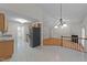 View of the kitchen with stainless steel appliances, chandelier, and plenty of countertop space at 205 Smiths Creek Dr, Clayton, NC 27520