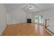 Open living room with a vaulted ceiling, hardwood floors, and a charming fireplace at 205 Smiths Creek Dr, Clayton, NC 27520