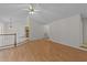 Spacious living room featuring wood floors, white ceiling fan, and neutral walls at 205 Smiths Creek Dr, Clayton, NC 27520