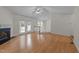 Spacious living room featuring hardwood floors, fireplace, and French doors at 205 Smiths Creek Dr, Clayton, NC 27520