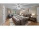 This main bedroom features a ceiling fan, wood flooring, and stylish decor at 205 Smiths Creek Dr, Clayton, NC 27520