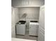 A laundry room features a new white washer and dryer, plus overhead shelving at 2118 Terrawood Dr, Durham, NC 27703