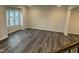 This living room features hardwood floors and a large window that provides natural lighting at 2118 Terrawood Dr, Durham, NC 27703