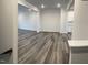 Open-concept living space featuring wood-look floors and an abundance of natural light at 2118 Terrawood Dr, Durham, NC 27703