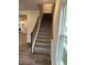 Carpeted stairs boast an elegant wood railing that leads to the upper level at 2118 Terrawood Dr, Durham, NC 27703
