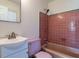 Cozy bathroom features a matching pink toilet, sink, and bathtub with retro tile surround at 2143 Ridge Rd, Raleigh, NC 27607
