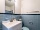 Bathroom with blue tiles, white sink, and a vintage blue toilet at 2143 Ridge Rd, Raleigh, NC 27607