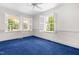 Bedroom features bright light from windows with white shutters and blue carpet at 2143 Ridge Rd, Raleigh, NC 27607