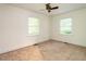 Bedroom with neutral carpet, ceiling fan, and two windows with blinds at 2143 Ridge Rd, Raleigh, NC 27607