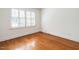 Bedroom with hardwood floors and shuttered window at 2143 Ridge Rd, Raleigh, NC 27607
