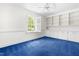 Bedroom features built in shelving, bright light from large windows with blue carpet at 2143 Ridge Rd, Raleigh, NC 27607