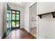 Light-filled foyer with hardwood floors, and green front door at 2143 Ridge Rd, Raleigh, NC 27607