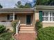 Inviting front entrance with a charming porch and well-maintained landscaping at 2143 Ridge Rd, Raleigh, NC 27607