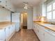 Traditional kitchen featuring white cabinets and standard appliances at 2143 Ridge Rd, Raleigh, NC 27607