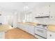 The kitchen features white cabinets, countertops, and appliances at 2143 Ridge Rd, Raleigh, NC 27607
