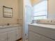 Bright laundry room with white cabinets and tile floors at 2143 Ridge Rd, Raleigh, NC 27607